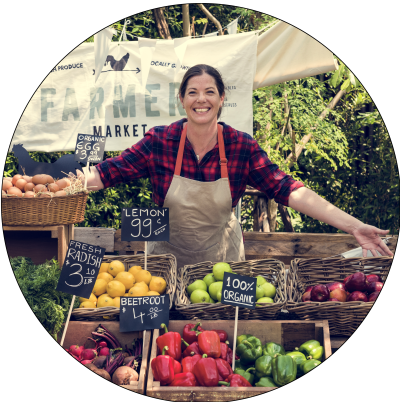 lady selling produce at a farmer's market